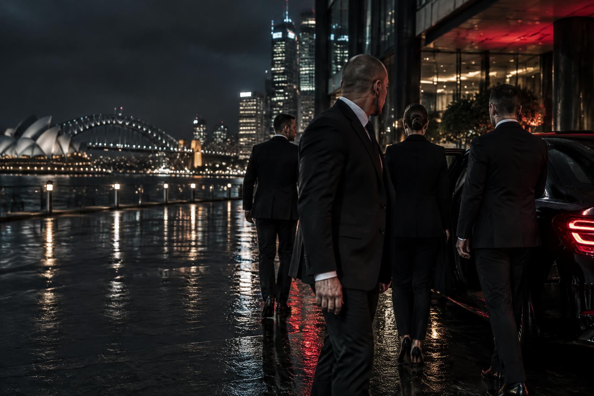 Close protection detail accompanying a client beside Sydney Harbour
